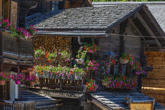 Old wooden house with wooden shingle roof and flower boxes in the historic centre of Grimentz, Val d'Anniviers, Valais Alps, Canton Valais, Switzerland
