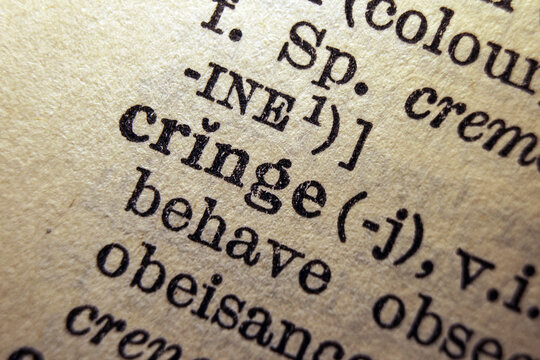 Word cringe on dictionary page, macro close up