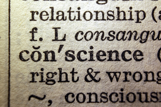 Word conscience on dictionary page, macro close up
