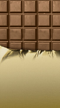 A vertical close-up of a classic milk chocolate bar, partially unwrapped from its elegant gold foil packaging