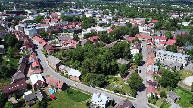 Drone shot moving over the historic city center, focusing on the beautiful Viljandi Music School building and surrounding cultural area in 2026.