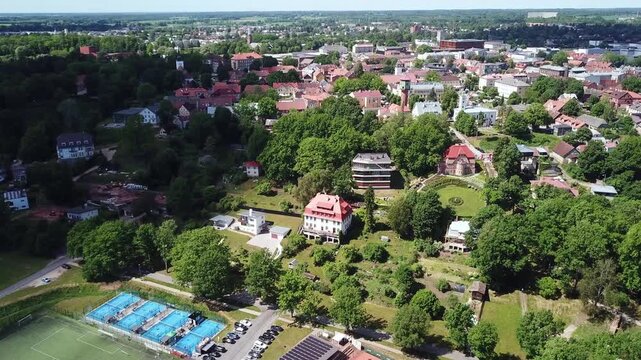 Beautiful drone shot of a scenic lakeside town, showcasing the peaceful summer landscape and natural environment of Viljandi, Estonia in 2026.