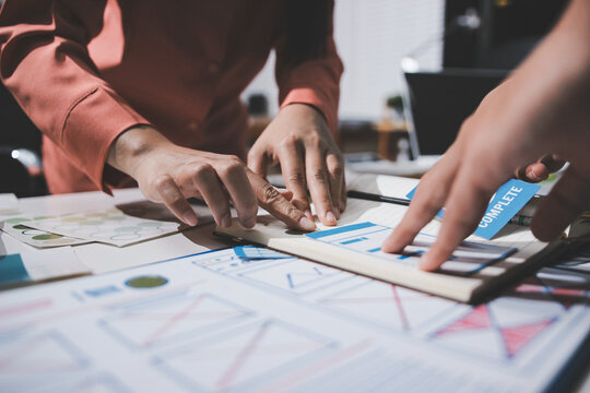 UI designer and UX developer brainstorm idea to design the application appearance in the early stage. Creative digital development agency. UX UI concept