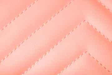 Naklejka premium Textured soft peach quilted leather material with decorative chevron stitching pattern background