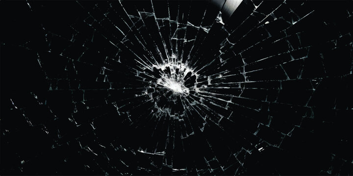 Broken glass texture with cracks and shattered pieces on a dark black background
