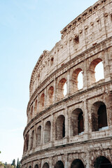 Fototapeta premium Visitors explore the ancient structure of the Colosseum in Rome during the daytime hours