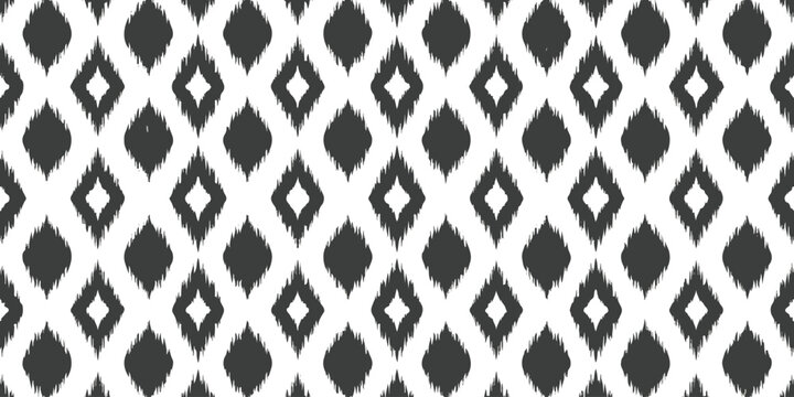 Seamless ikat pattern with diamond shapes in black and white ethnic textile style