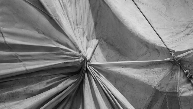sailcloth. Close-up of heavy sailcloth showing complex folds and tensile textures. mobility guides, transit brochures, designed for mobility and urban transit guides, used by presentation designers.