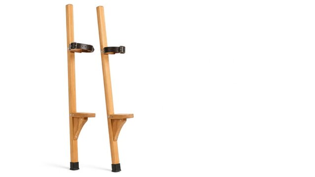 Pair of wooden stilts with footrests and adjustable leather straps on a white background