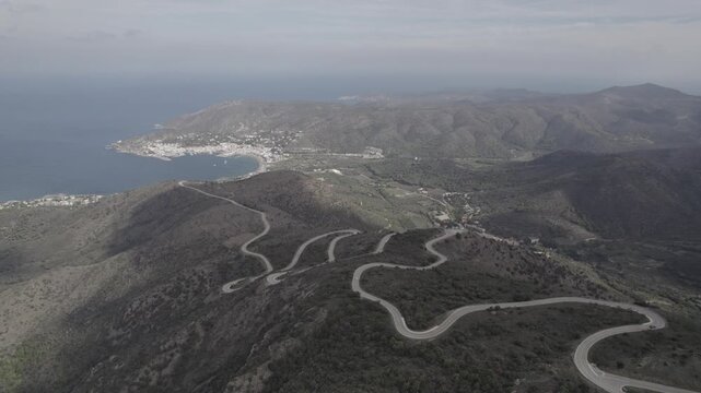 Aerial Drone Flyover Coastal Road Leading to Port de la Selva Town, Costa Brava, Spain
