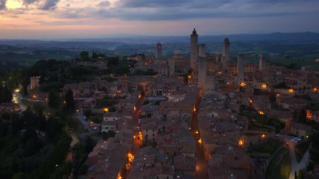 San Gimignano at night, aerial view of Italian historic village of San Gimignano at night with night illumination, travel in Tuscany, Italy