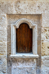 Fototapeta premium close up of wooden hatch in rabat, Mdina, Malta used in history to dispose of children shot in summer sunlight