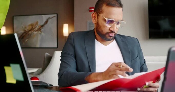 Man reviewing documents at office desk