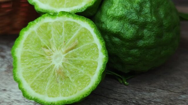 Fresh kaffir lime fruit on a wooden floor.