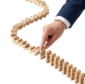 Businessman hand stopping falling wooden dominoes with stop sign