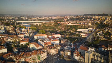 Obraz premium Aerial golden hour view of Porto historic center with Douro River Dom Luis I Bridge Porto Cathedral rooftops and city streets in Porto Portugal
