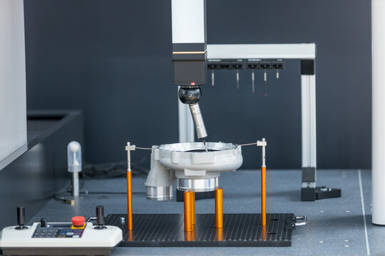 Motorized indexing probe head inspecting precision metal component on coordinate measuring machine in advanced quality control laboratory. Reverse engineering concept.