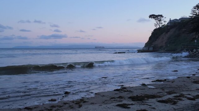 Gimbal close-up panning shot of serene Cabrillo Beach in San Pedro at sunset in South California. 4K