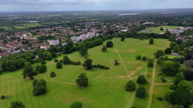 Aerial wide establishing shot of Prospect Park, Reading, UK, on an overcast day with cityscape