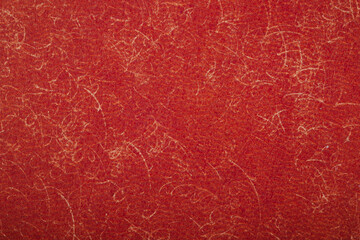 Fototapeta premium Close up texture of red textured paper with abstract swirling line details for backgrounds
