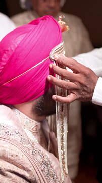 Vertica lMid Shot of Sikh Indian Groom Sehrabandi or Tying of the Sehra Ceremony