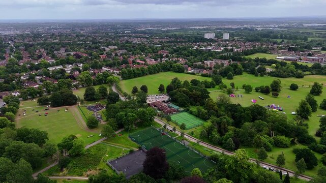 Aerial wide shot of Prospect Park Reading, with sports courts, fields, and urban landscape