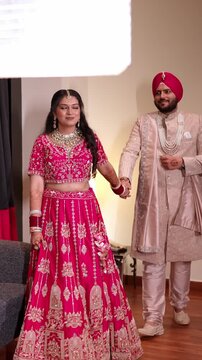 Vertical Wide Shot of Romantic Indian Bride and Groom Walking While Holding Hands at Wedding Day