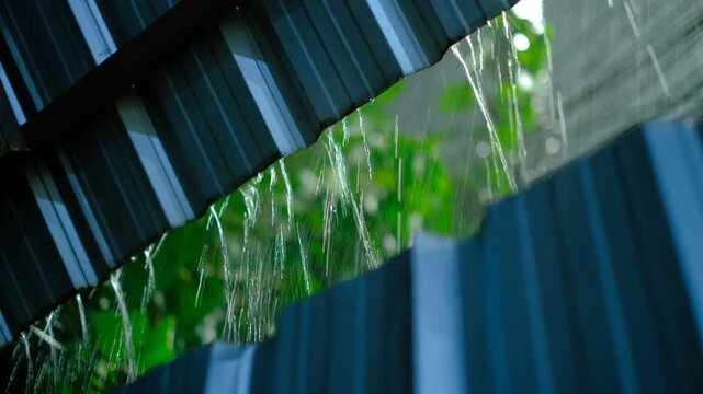 Rain trickles off blue roofing