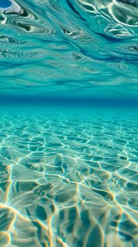 Clear turquoise water with sunlight reflections and underwater ripples in a tropical ocean.