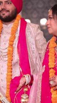 Vertical Shot of Indian Bride and Groom Walking Together After Wedding Ceremony