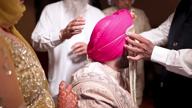 Mid Shot of Sikh Indian Groom Sehrabandi or Tying of the Sehra Ceremony
