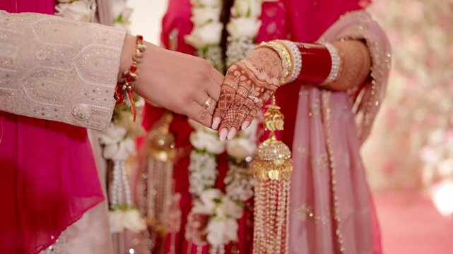 Closeup Shot of Bride and Groom Holding Hands After Ring Ceremony 
