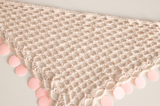 Comeback of crochet fashion shown in triangle sequin bandana, comeback accessory worn on head or around waist for boho look, comeback trend proves handmade never goes out of style.