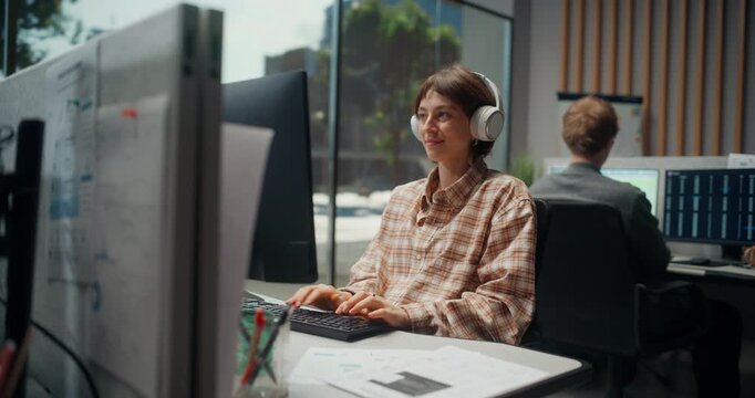 Portrait of Female Software Designer Builds Secure AI Web and Mobile Apps in Office, Code, UI Ecommerce Features While Collaborating With Video Game Developer on Product Engineering. Working Computer