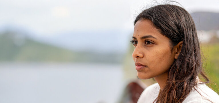 Thoughtful young woman looking away with serious expression