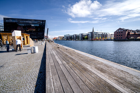 People in front National Library in Copenhagen by the water canal, Indre Bym Denmark.