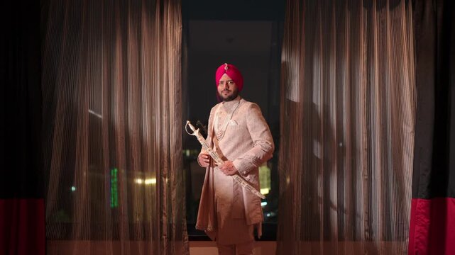 Mid Shot of Sikh Groom Standing with Kirpan and Smiling in Camera before Wedding