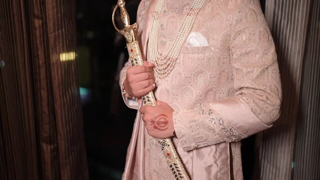 Closeup Revealing shot of Sikh Groom Standing with Kirpan For Wedding