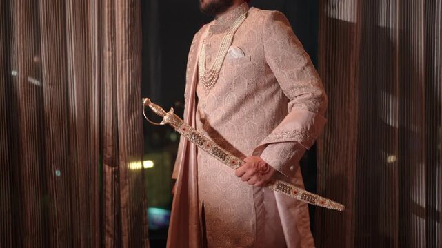 Revealing shot of Sikh Groom Standing with Kirpan For Wedding