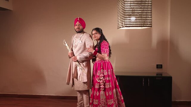 Sikh Bride and Groom Posing in Camera in Wedding Attire