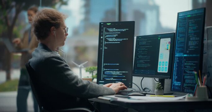 Light-skinned Young Male Software Engineer in Office Typing and Coding Across Vertical Screens, Using Code Editor and App Ui Preview to Build Secure Data Interface, Automation Ai Project.