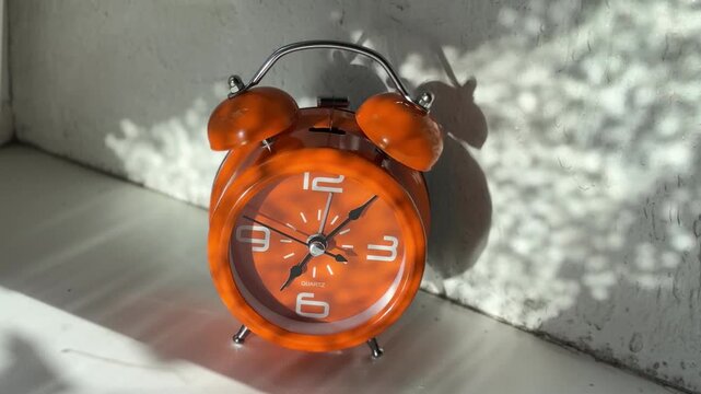 Ticking vintage clock swinging in sunlight for morning motivation and deadline concept

