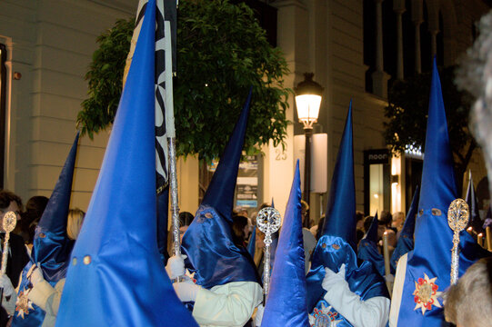 Nazarenos with blue hoods from Montserrat Brotherhood during Holy Week procession in Seville