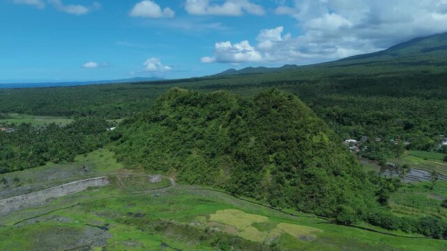 Aerial view of lush mountains and forests fill the landscape in Tabaco City, Albay Philippines. Ideal for themes of nature,  travel.
