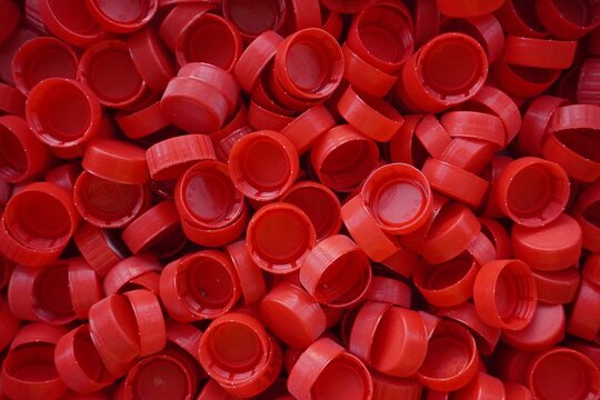 Close-up of the red plastic caps. Uniform texture and dense structure.