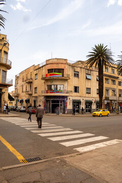 Crosswalk in front of a corner building with a large Eritrean flag, in downtown Asmara, Eritrea