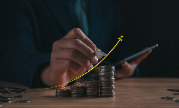 businessman drawing rising arrow graph over stacked coins with percent. concept compound interest growth, financial wealth accumulation, investment returns, retirement savings, banking asset profit.