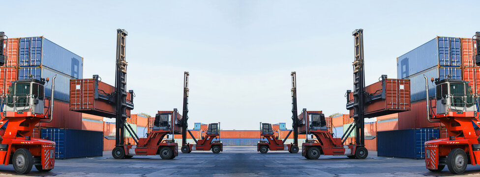 Red container handlers operate heavy-duty equipment moving cargo containers at busy port under expansive blue sky, showcasing powerful logistics and global trade operations..