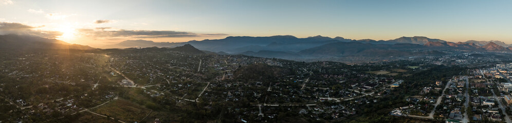 Fototapeta premium Aerial view of Mutare city at sunset with mountains