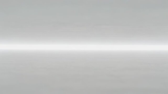 Advancing playback showing subtle tone shifts on studio gray surface with central light band